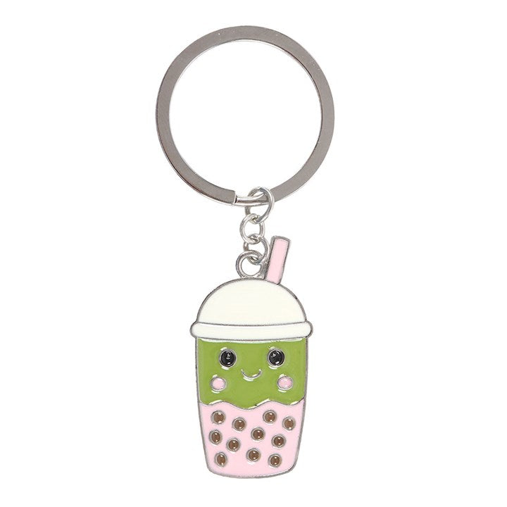 Keychain shaped like a cartoon bubble tea with a smiley face on a white background