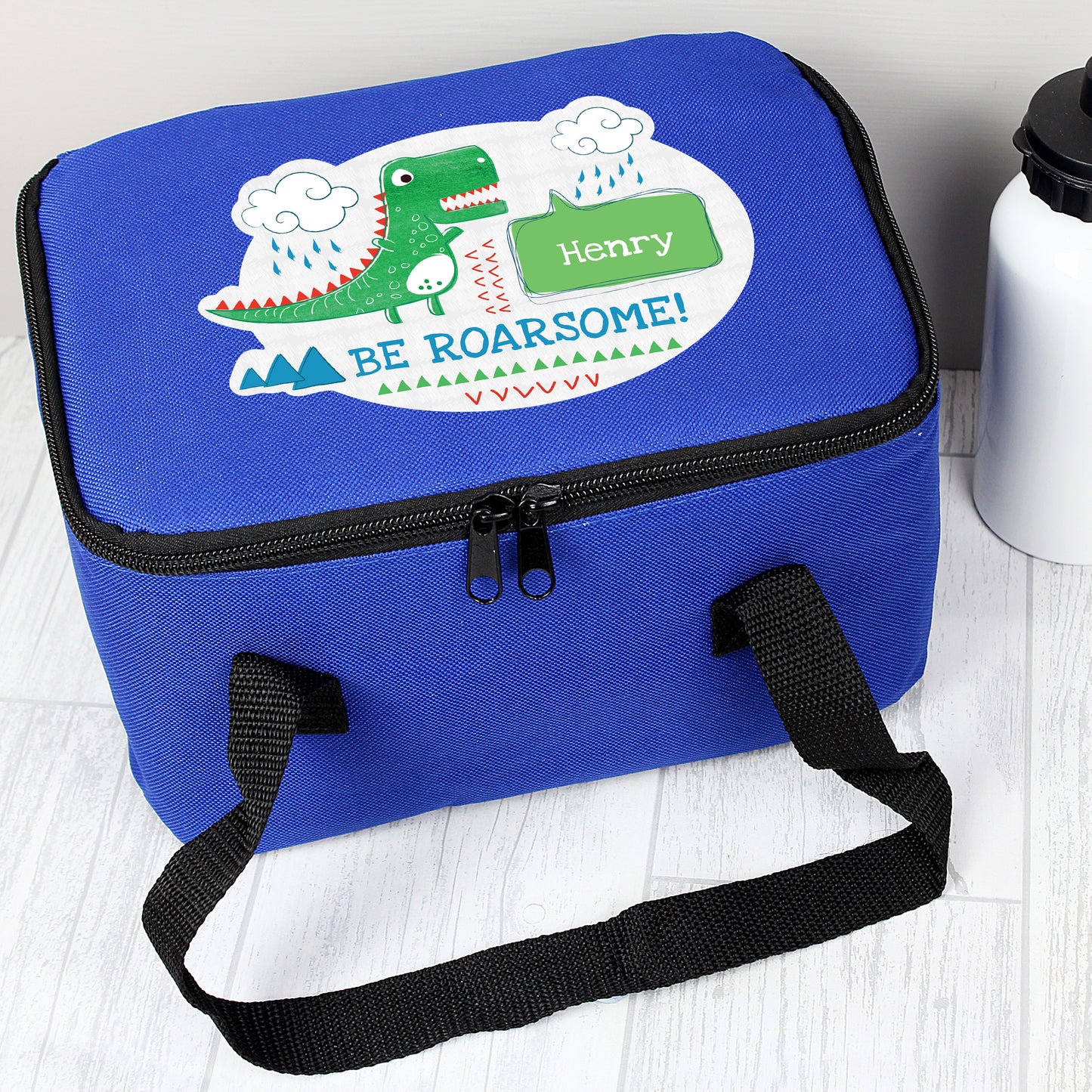 Blue lunch bag with dinosaur picture and personalised with name