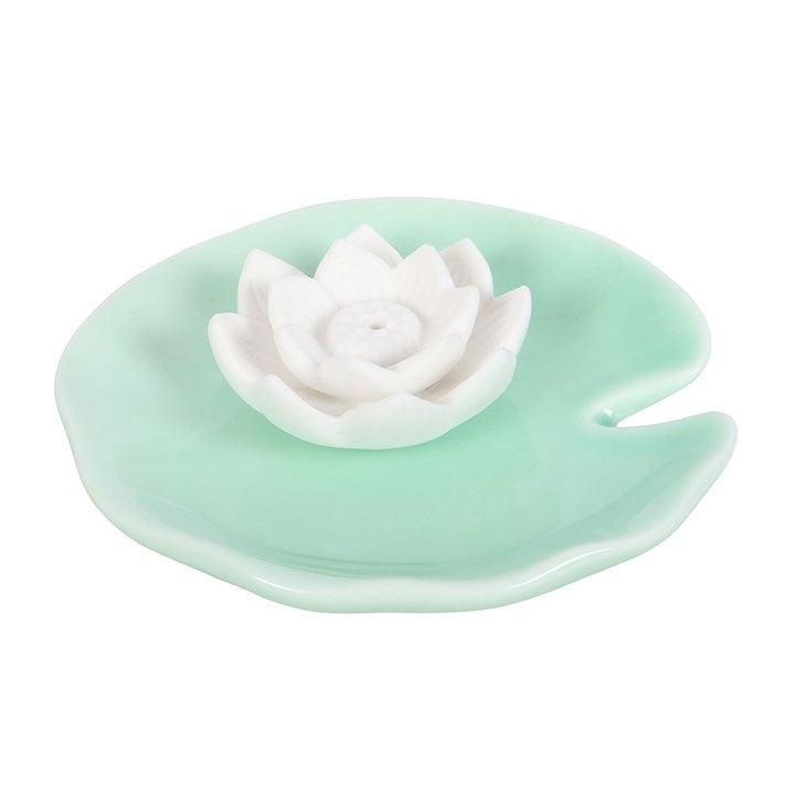 Mint green ceramic dish with a white ceramic lotus flower on a white background
