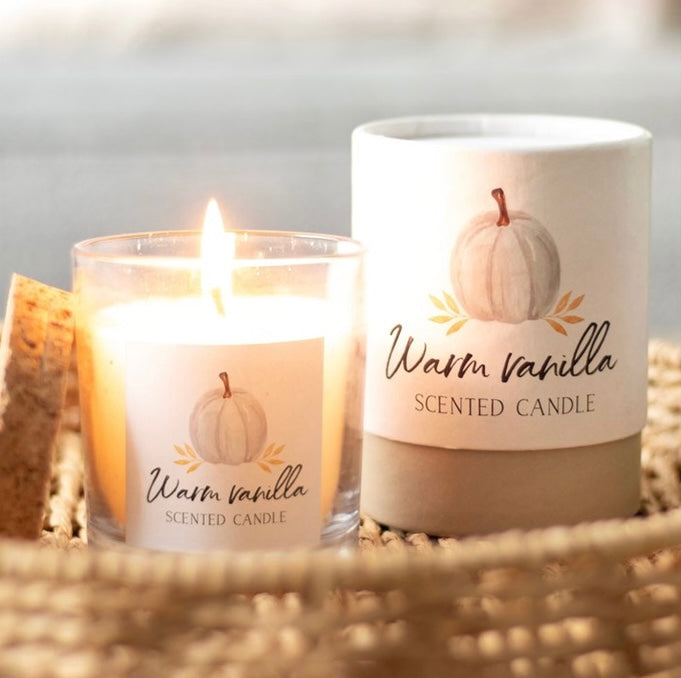 Warm vanilla autumn candle in glass jar with cork lid and gift box