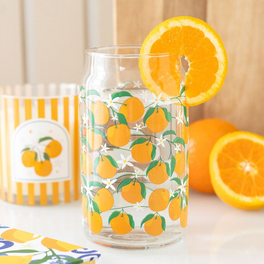 Clear glass jar with orange design, filled with water and an orange slice, on a white background.