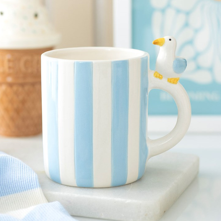 Striped mug with a seagull sitting on the handle