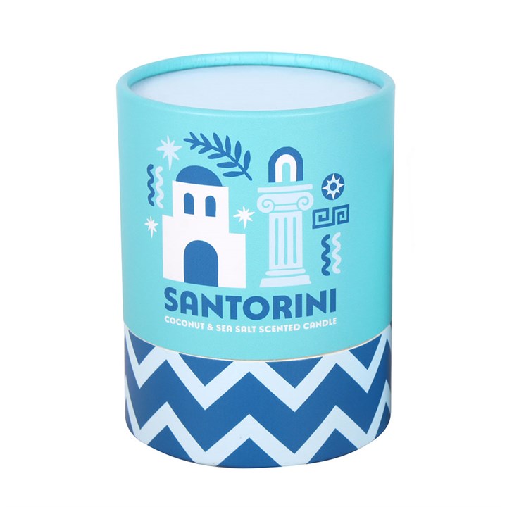 Cylindrical candle in a blue container with Santorini design and text.