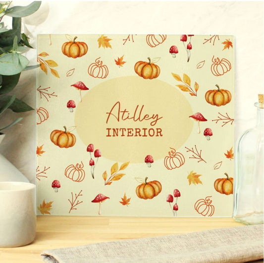 Glass chopping board feature a pumpkin design and personalised with a name
