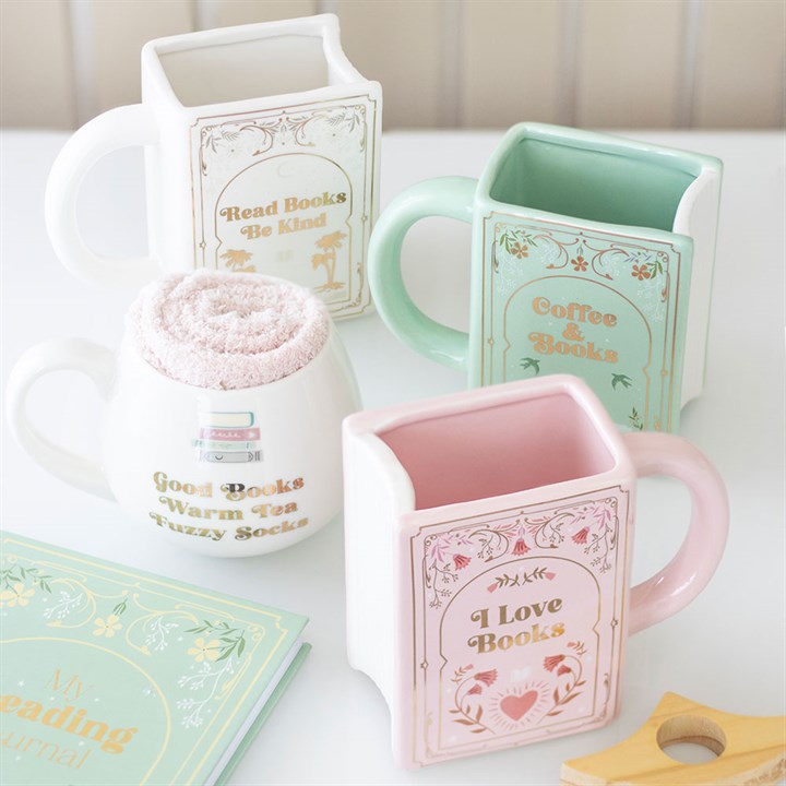Set of book-themed mugs on a white surface.