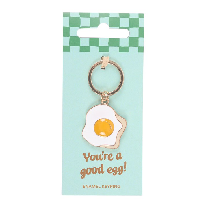 Keychain shaped like a fried egg on a green and white checkered card with 'You're a good egg!' text.