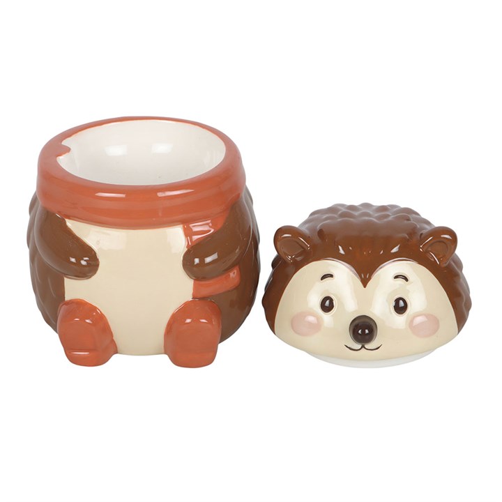 Hedgehog-shaped oil burner with a face on a white background