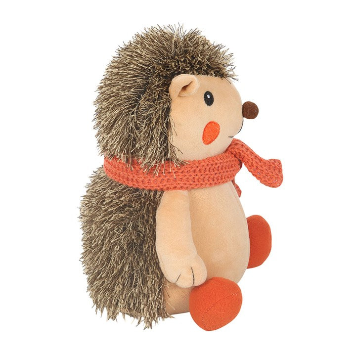 Plush hedgehog doorstop with an orange scarf.