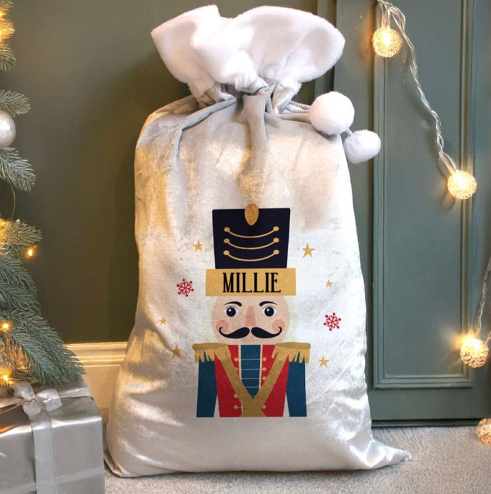 Personalised Christmas sack with nutcracker design and name 'Millie' against a festive background.