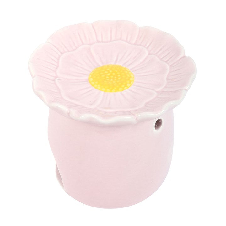 Pink flower-shaped oil burner with a yellow centre on a white background