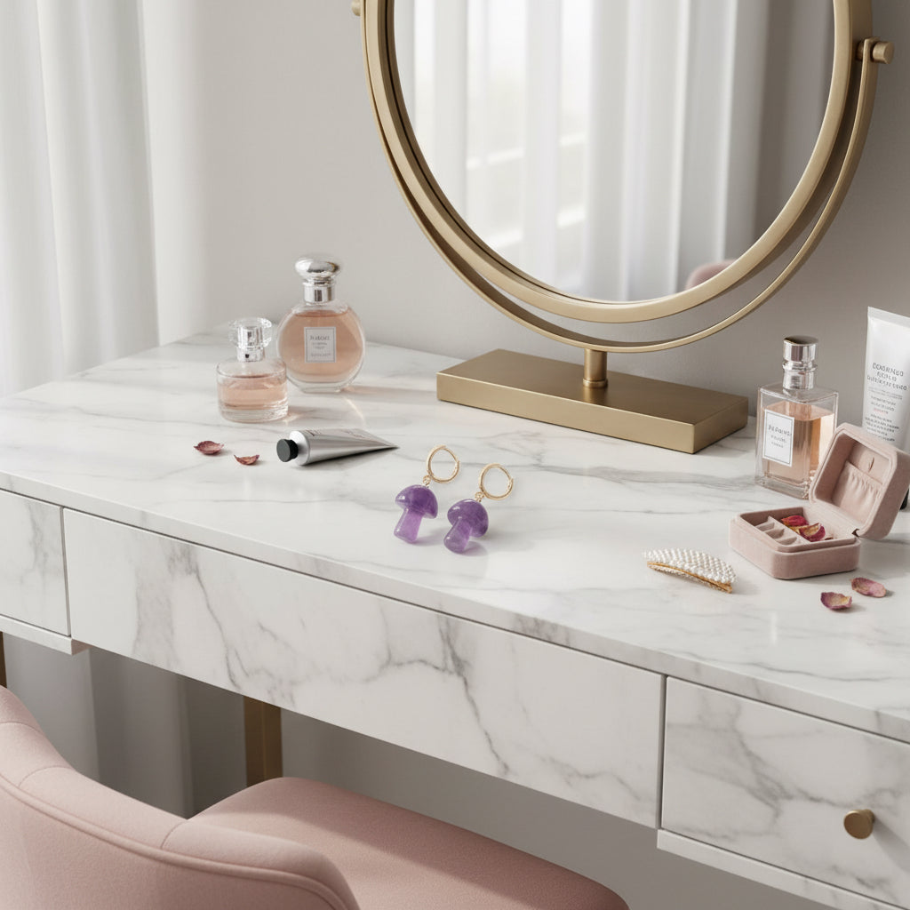 Purple mushroom-shaped earrings with gold hoop components on a white background