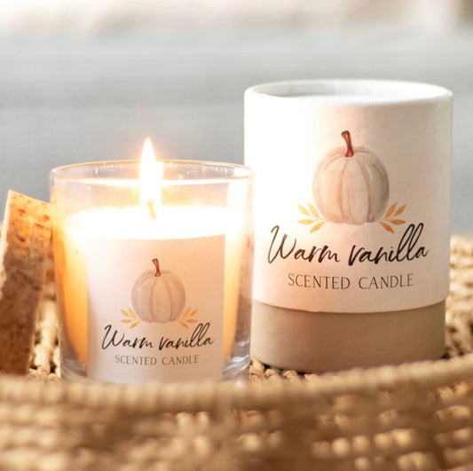 Warm vanilla autumn candle in glass jar with cork lid and gift box