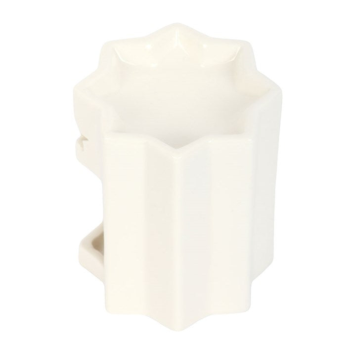 White geometric candle holder on a white background