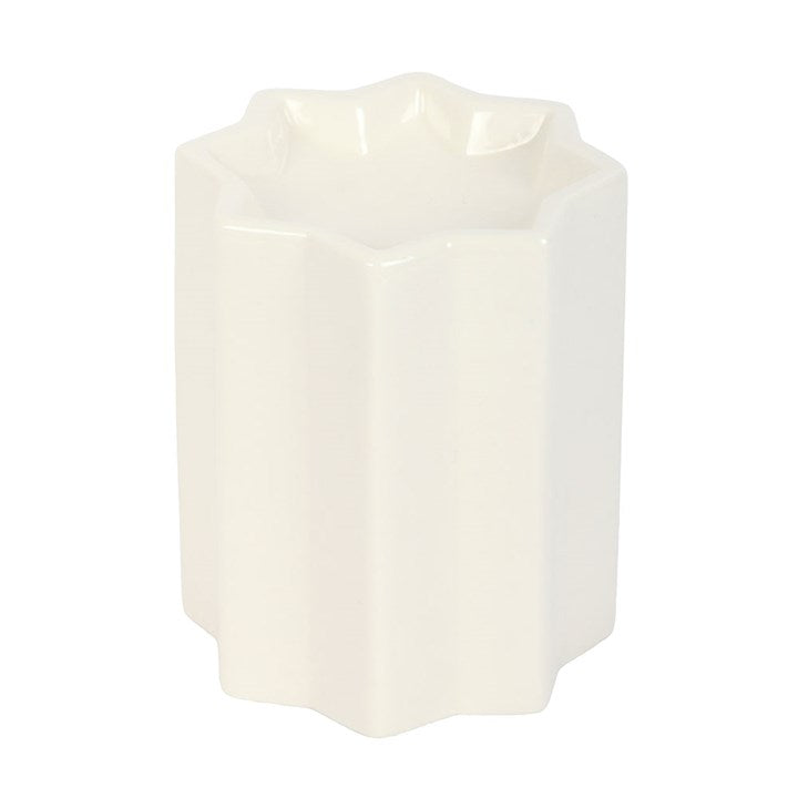 White ceramic oil burner with a geometric design on a white background