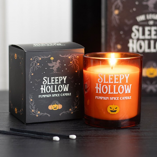 Sleepy Hollow pumpkin spice candle with packaging on a dark surface