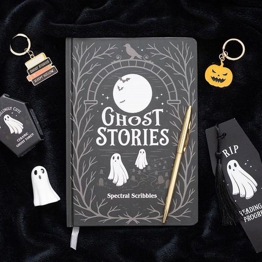 Notebook titled 'Ghost Stories' with ghost-themed accessories on a dark background