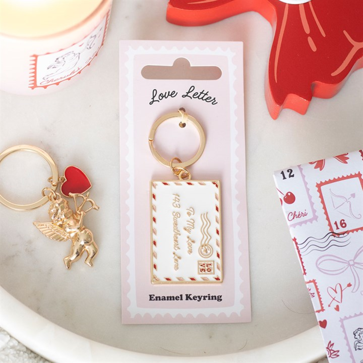 Enamel keyring with heart and angel charm on a 'Love Letter' packaging.