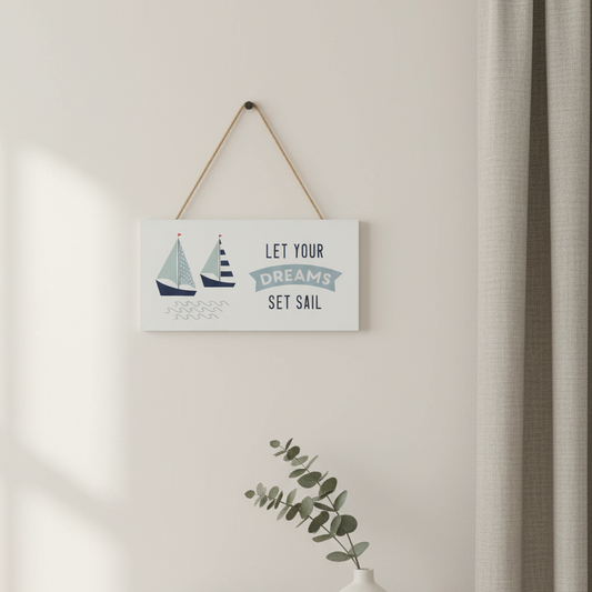 Decorative sign with sailboats and text on a wall above a shelf with folded clothes and a vase.